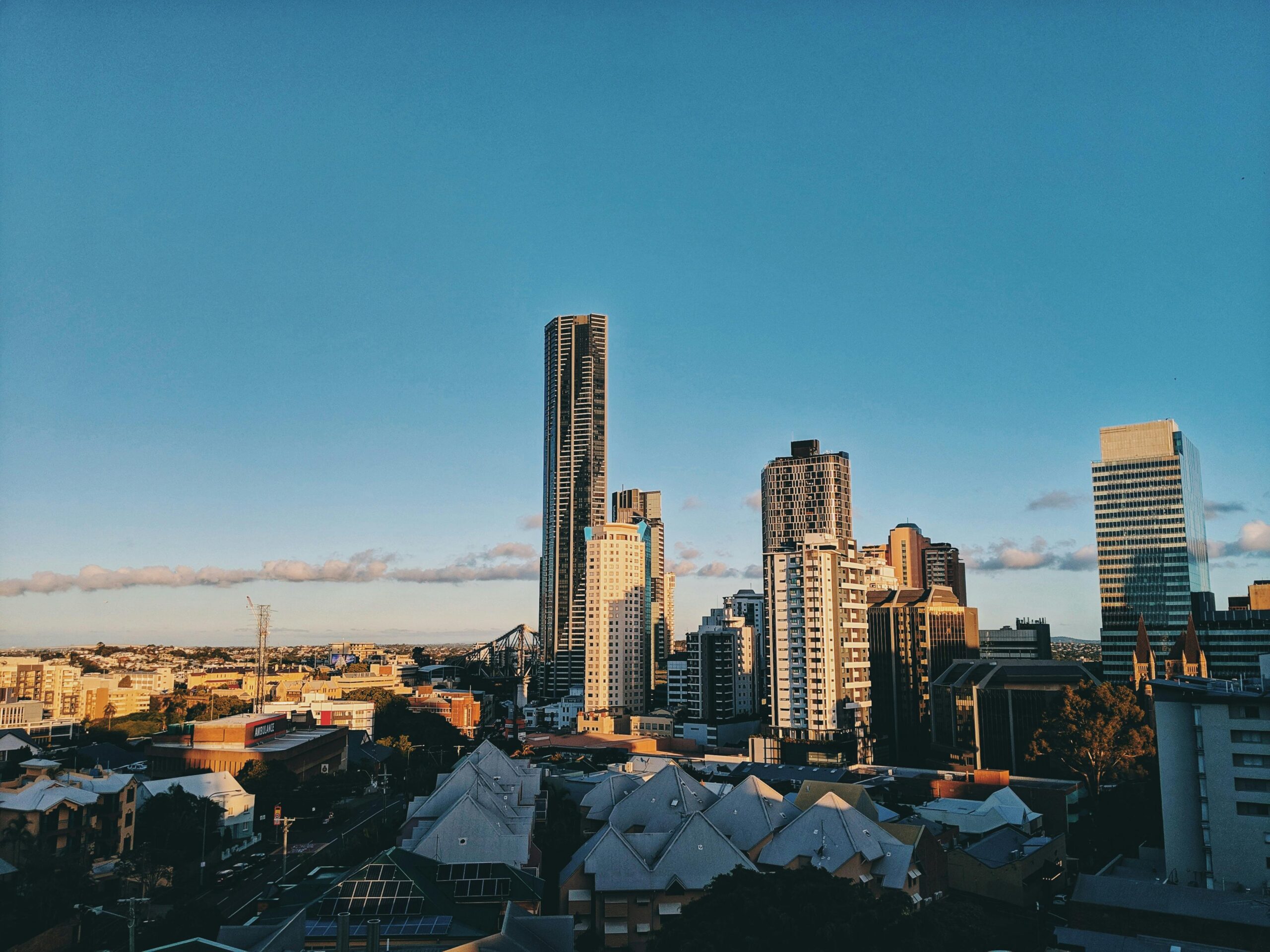 A stunning view of Brisbane's modern skyline featuring towering skyscrapers against a clear blue sky.